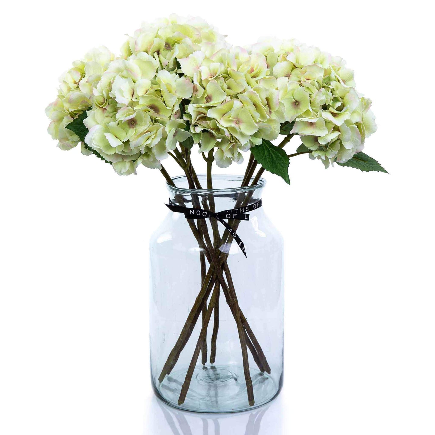 Large green faux hydrangea bouquet in apothecary vase