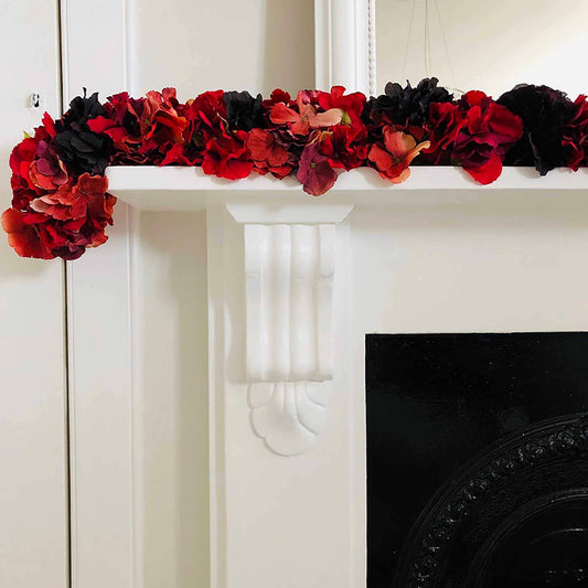 Red and plum faux hydrangea garland on mantle